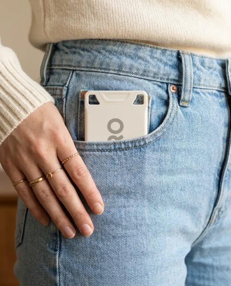 The white VORO card in the front pocket of light jeans, the denim flat.
