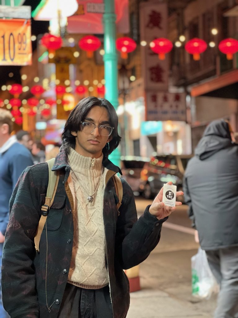 A pre-launch tester holding an VORO lip balm prototype at night.